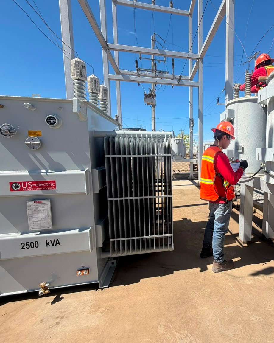 US Electric 2,500 kVA substation transformer in service, technician at the unit
